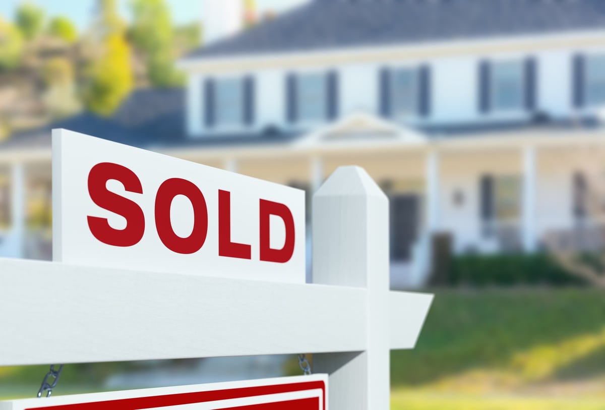 House with sold sign — property turnover and pre-sale painting services