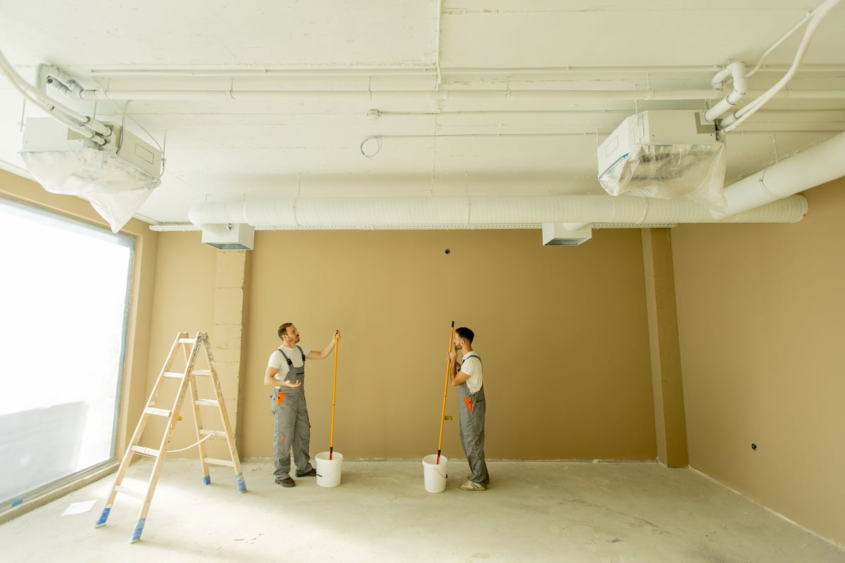Professional commercial painters painting a large office interior